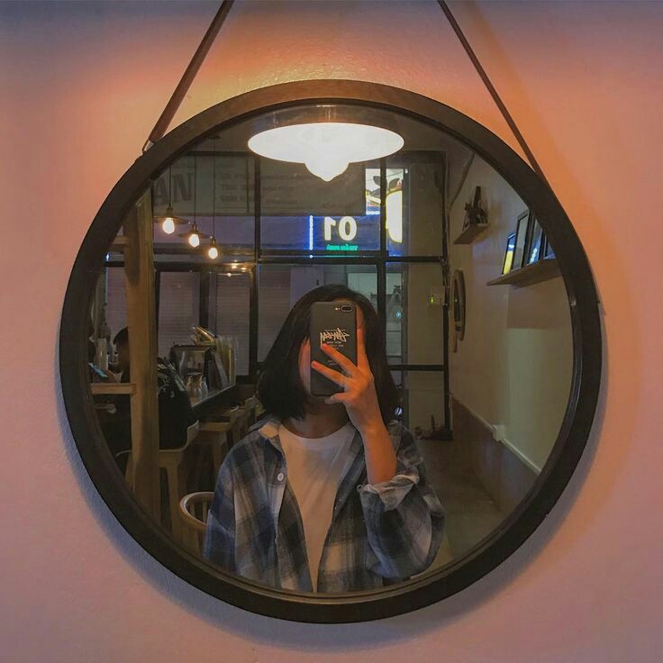 Download A Woman Taking A Selfie In A Mirror  Wallpaperscom
