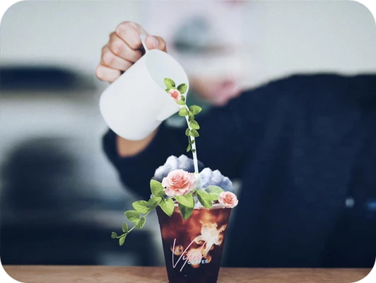 girl pouring water on the cup with rose stickers